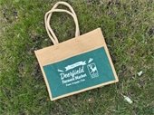 photo of a brown and green tote bag that says "Deerfield Farmers Market - Food, Friends, Fun"