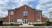 Photo of the West Deerfield Township red brick building in front of a blue sky looking north