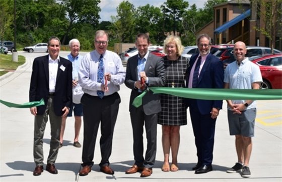 Photo of people smiling while cutting the ribbon at Zion Woods
