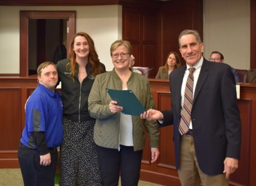 Mayor Shapiro hands a World Down Syndrome Day proclamation to representatives of Gigi's Playhouse.