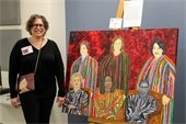Kimberly Perl next to her painting of female Supreme Court Justices