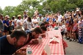 People competing in a the pie eating contest