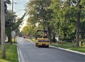 Photo of a yellow roller truck flattening pavement on Havel Avenue
