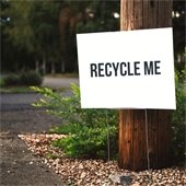White yard sign with text "Recycle Me"