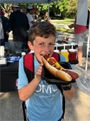 Child eating a giant hotdog