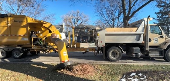 Photo of a vacuum truck sucking up leaves