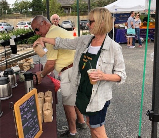 Photo of people looking at coffee products at the Market