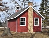 Photo of the little red school house in the Historic Village